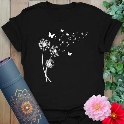 Black yoga t-shirt with delicate dandelion seeds transforming into butterflies