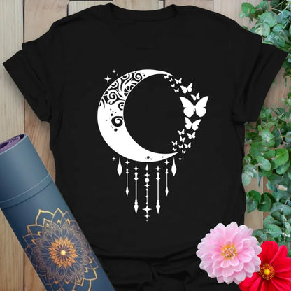 Black yoga t-shirt with intricate crescent moon, stardust trails, and butterfly design