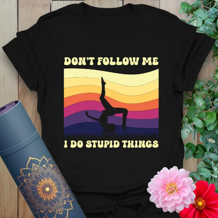 Black yoga t-shirt with colorful retro sunset and playful handstand silhouette design