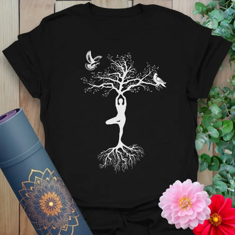 Black yoga t-shirt featuring white tree pose yogi with flying doves design