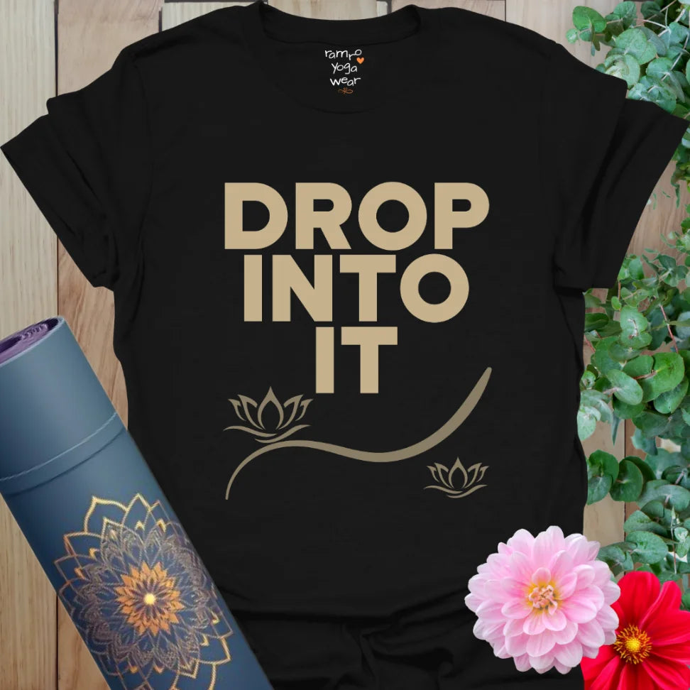 Black Drop Into It T-Shirt featuring bold stacked lettering and minimalist lotus design. A grounding yoga tee for breathwork and calm style.