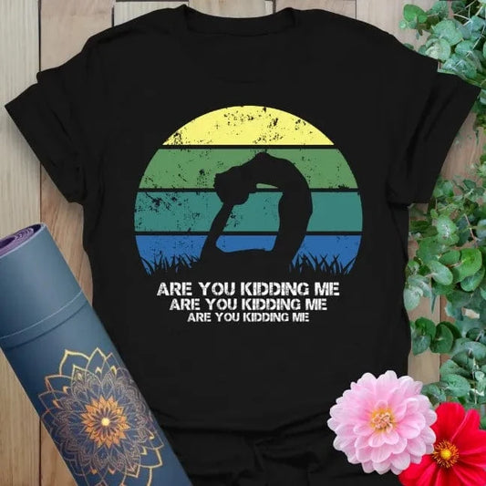 Classic black cotton yoga t-shirt featuring retro yogi sunset graphic and cheeky mindful living message.