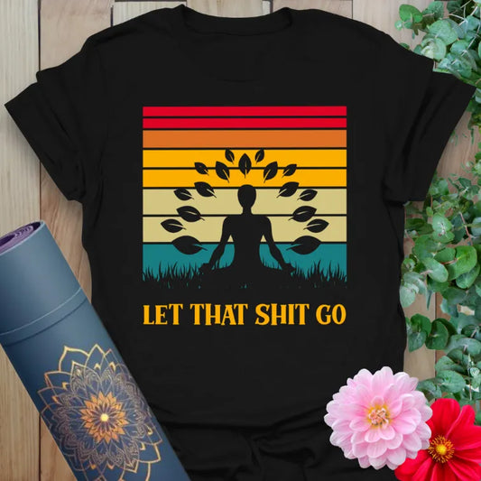 Classic black cotton yoga t-shirt showcasing colorful retro sunset, meditating yogi, and humorous letting-go mantra.
