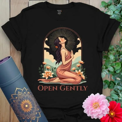 Classic black cotton yoga t-shirt showcasing elegant heart-opening yoga pose framed by blooming flowers and radiant skies.