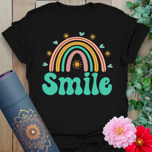 Classic black cotton yoga t-shirt showcasing colorful rainbow, hearts, and uplifting "Smile" mantra for joyful, conscious movement.