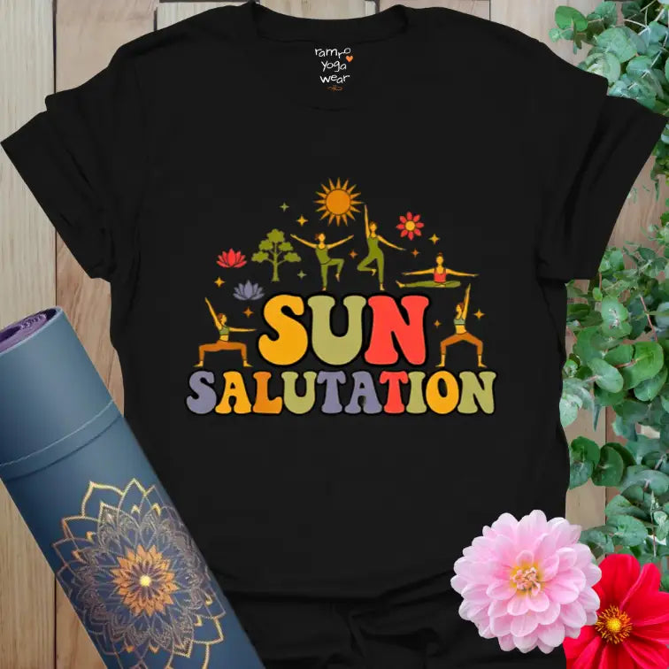 Black Sun Salutation T-Shirt with radiant orange and yellow sunrise design. A grounding yoga tee for focused, soul-bright practice.