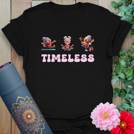 Classic black cotton tee with playful elder characters and bold pink “TIMELESS” typography for soulful, active lifestyle wear.