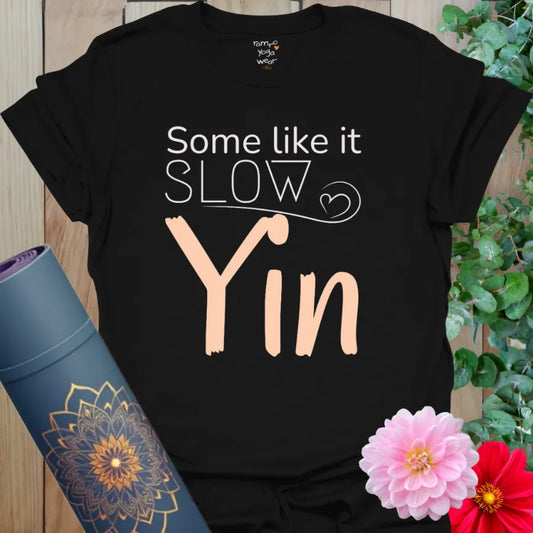 Black Yin T-Shirt with bold contrast peach and white design. Slow yoga shirt with grounding simplicity.