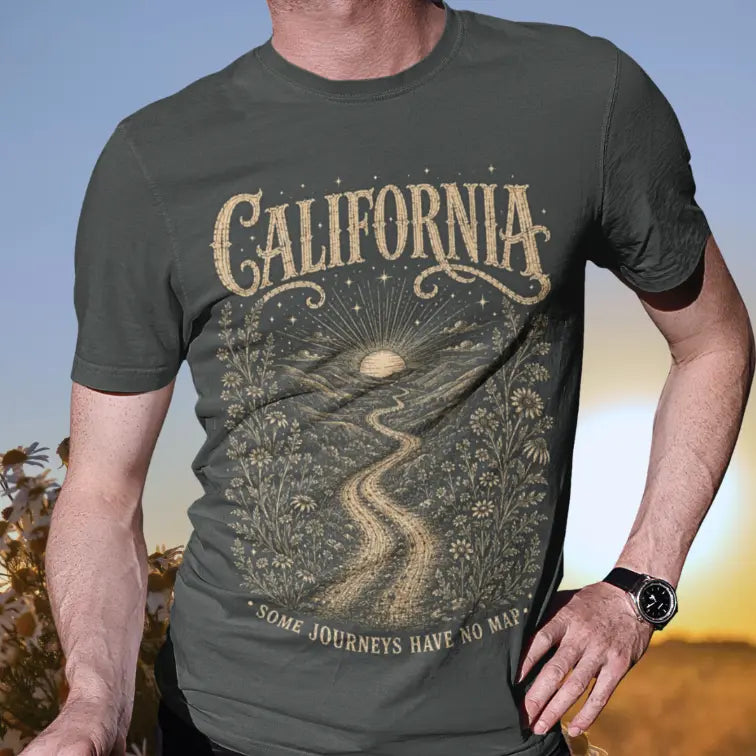 Person wearing a short sleeved tee called California in Dark Heather Grey. A sacred yoga shirt at golden hour in an open field — Sacred Thread collection by Ramro Yoga Wear