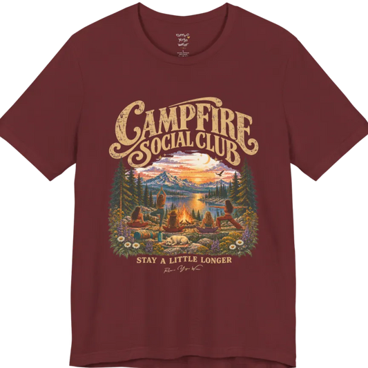 A short sleeved tee called the Campfire T-Shirt, flat lay and a Bella+Canvas 3001. Simply says, Campfire Social Club. Stay A Little Longer. Design highlights five women seen from behind practicing yoga around a campfire on a rocky lakeside overlook at sunset, one in tree pose, one in warrior pose and three seated, with a sleeping white dog, snow-capped mountains, pine trees and wildflowers. Color is Heather Cardinal.