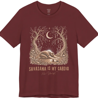 A short sleeved grunge tee with an illustrated figure collapsed in child's pose beneath gnarled trees and a crescent moon, coffee cup and phone nearby, text reading "Savasana Is My Cardio" — Funny Yoga Shirts collection by Ramro Yoga Wear in Heather Cardinal.