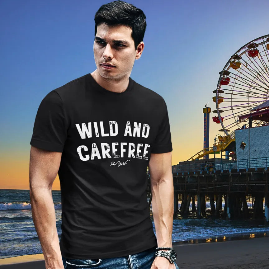 Person wearing Carefree black tee, a  yoga shirt at the beach at sunset with a pier in the background — Funny Yoga Shirts collection by Ramro Yoga Wear