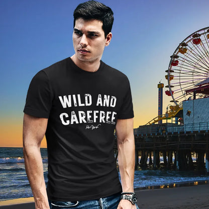 Person wearing Carefree black tee, a  yoga shirt at the beach at sunset with a pier in the background — Funny Yoga Shirts collection by Ramro Yoga Wear