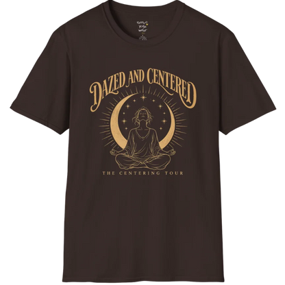 A short sleeved tee called the Centered T-Shirt, flat lay and a soft cotton shirt. Simply says, Dazed and Centered, The Centering Tour. Design highlights a person meditating in lotus pose beneath a gold crescent moon with radiating rays and a ring of small stars. Color is Dark Chocolate.