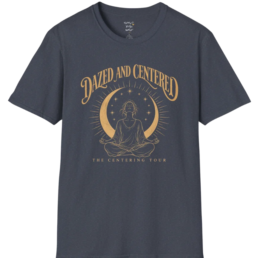 A short sleeved tee called the Centered T-Shirt, flat lay and a soft cotton shirt. Simply says, Dazed and Centered, The Centering Tour. Design highlights a person meditating in lotus pose beneath a gold crescent moon with radiating rays and a ring of small stars. Color is Heather Navy.