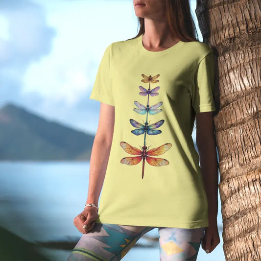 Woman wearing Change T-Shirt in soft yellow tone with vibrant dragonfly artwork and peaceful everyday styling.