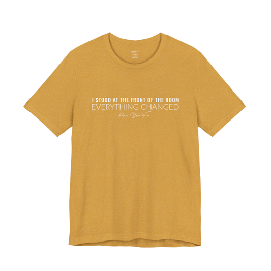 I STOOD AT THE FRONT OF THE ROOM EVERYTHING CHANGED yoga teacher gift tee flat lay in Heather Mustard — Yoga Teacher Gifts collection by Ramro Yoga Wear
