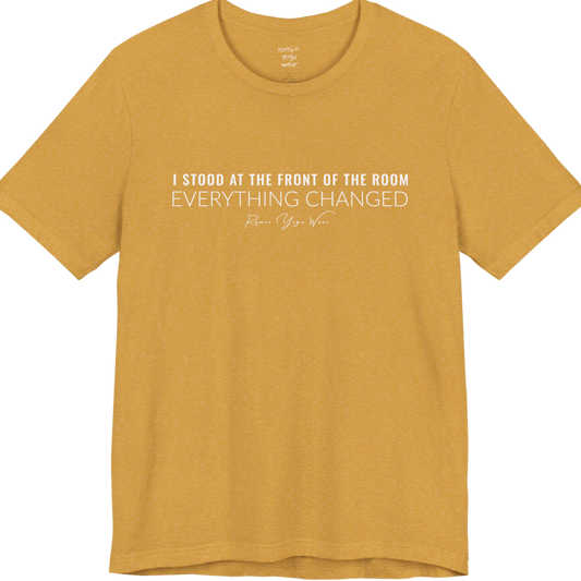 I STOOD AT THE FRONT OF THE ROOM EVERYTHING CHANGED yoga teacher gift tee flat lay in Heather Mustard — Yoga Teacher Gifts collection by Ramro Yoga Wear