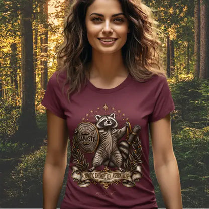 A smiling woman stands in a forest lit by golden-hour sunlight, wearing the Chaotic Zen T-Shirt. Chaotic Zen T-Shirt is a Bella+Canvas 3001 and the color is in the Heather Cardinal color.