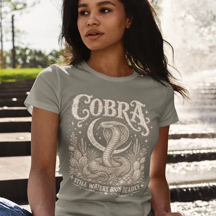 Person wearing the Cobra T-Shirt in Heather Military Green, standing outdoors near a set of steps — Wild Animals collection by Ramro Yoga Wear.