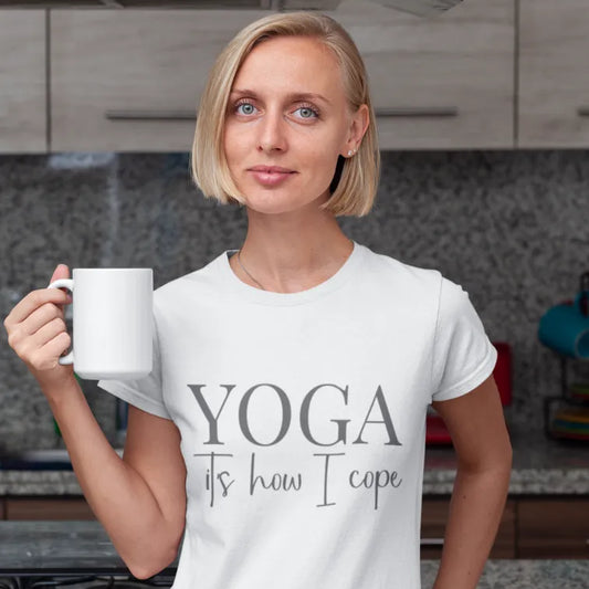 Woman wearing Cope T-Shirt with minimalist yoga typography while holding coffee in relaxed wellness-inspired lifestyle setting.
