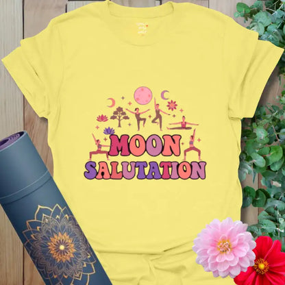 Cornsilk Moon Salutation T-Shirt with glowing pink moon and floral accents. Yoga shirt celebrating peaceful balance at day’s end.