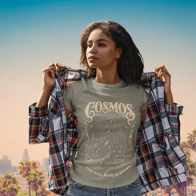 Lifestyle image of model wearing the Cosmos T-Shirt in a relaxed streetwear setting with vintage celestial artwork and soulful styling.