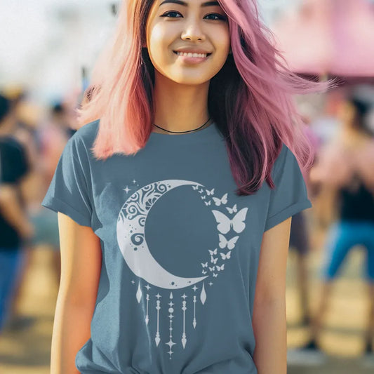 Woman wearing Indigo Blue Crescent Moon T-Shirt in relaxed outdoor lifestyle setting with calm spiritual yoga-inspired styling.