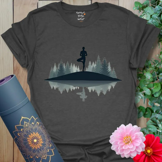 Dark Heather Grey Still Point T-Shirt with yoga Tree Pose figure and forest reflection. Subtle, grounded design with modern calm.