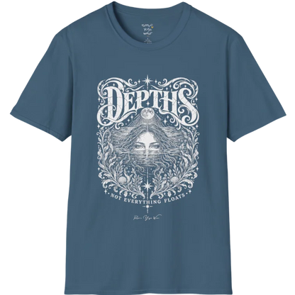 Short sleeved tee, illustration of a  woman submerged to the eyes in water, hair flowing into seaweed and shells, a full moon above her and stars scattered throughout, framed by ornate botanical linework. Depths T-Shirt flat lay is a Gildan 64000 and the color is Indigo Blue.