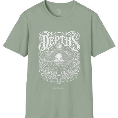 Short sleeved tee, illustration of a  woman submerged to the eyes in water, hair flowing into seaweed and shells, a full moon above her and stars scattered throughout, framed by ornate botanical linework. Depths T-Shirt flat lay is a Gildan 64000 and the color is Sage.