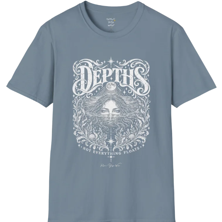 Short sleeved tee, illustration of a  woman submerged to the eyes in water, hair flowing into seaweed and shells, a full moon above her and stars scattered throughout, framed by ornate botanical linework. Depths T-Shirt flat lay is a Gildan 64000 and the color is Stone Blue.