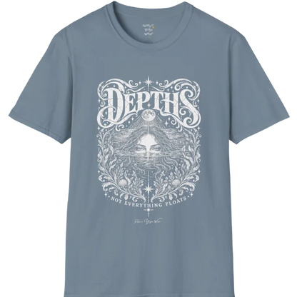 Short sleeved tee, illustration of a  woman submerged to the eyes in water, hair flowing into seaweed and shells, a full moon above her and stars scattered throughout, framed by ornate botanical linework. Depths T-Shirt flat lay is a Gildan 64000 and the color is Stone Blue.
