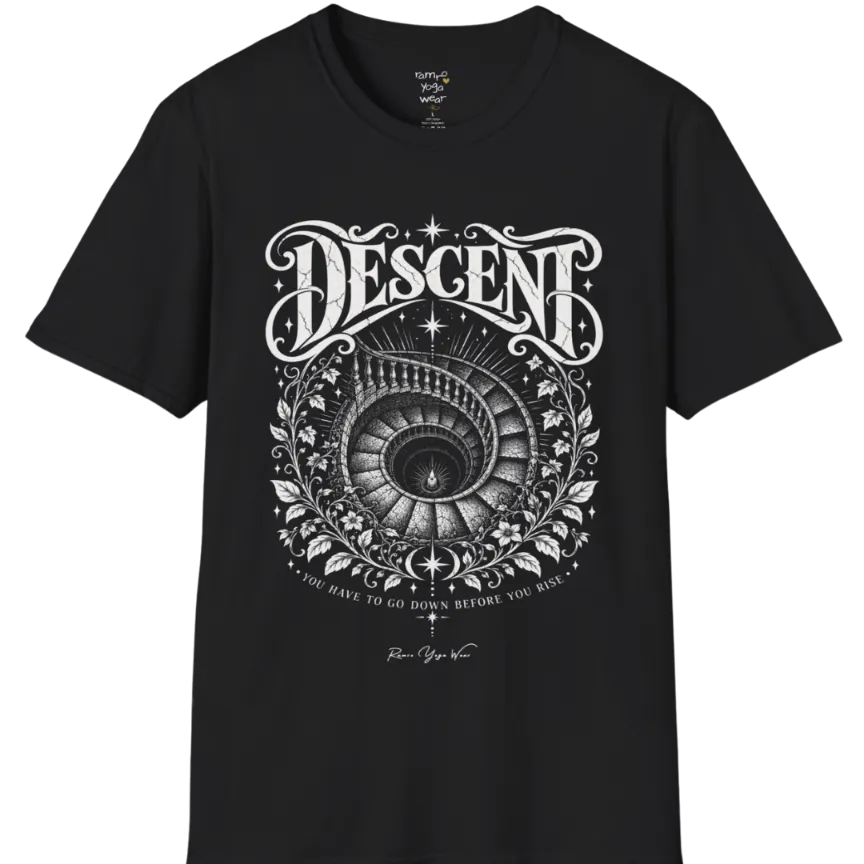 Spiral staircase descending into darkness with a single small light glowing at the bottom, fine botanical framing around the stairwell. Descent T-Shirt flat lay is a short sleeved tee, Gildan 64000 and the color is Black.