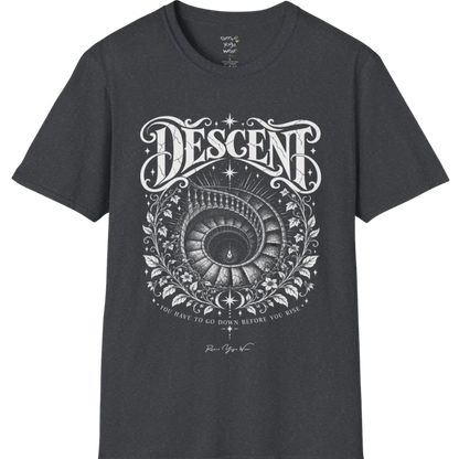 Spiral staircase descending into darkness with a single small light glowing at the bottom, fine botanical framing around the stairwell. Descent T-Shirt flat lay is a short sleeved tee, Gildan 64000 and the color is Dark Heather Grey.