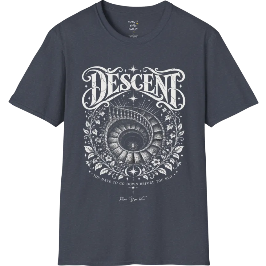 Spiral staircase descending into darkness with a single small light glowing at the bottom, fine botanical framing around the stairwell. Descent T-Shirt flat lay is a short sleeved tee, Gildan 64000 and the color is Heather Navy.