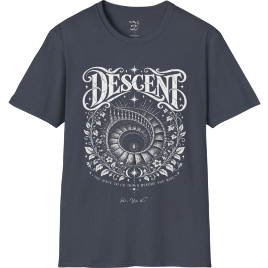 Spiral staircase descending into darkness with a single small light glowing at the bottom, fine botanical framing around the stairwell. Descent T-Shirt flat lay is a short sleeved tee, Gildan 64000 and the color is Heather Navy.