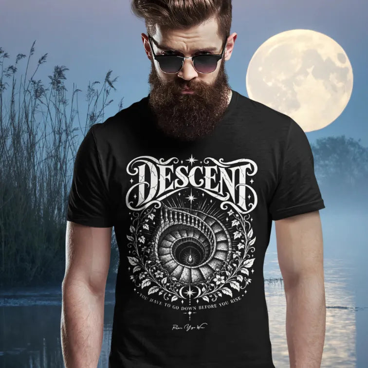 A bearded man in sunglasses stands by water at night with a full moon behind him, wearing the Descent T-Shirt. Descent T-Shirt is a Gildan 64000 and the color is black.