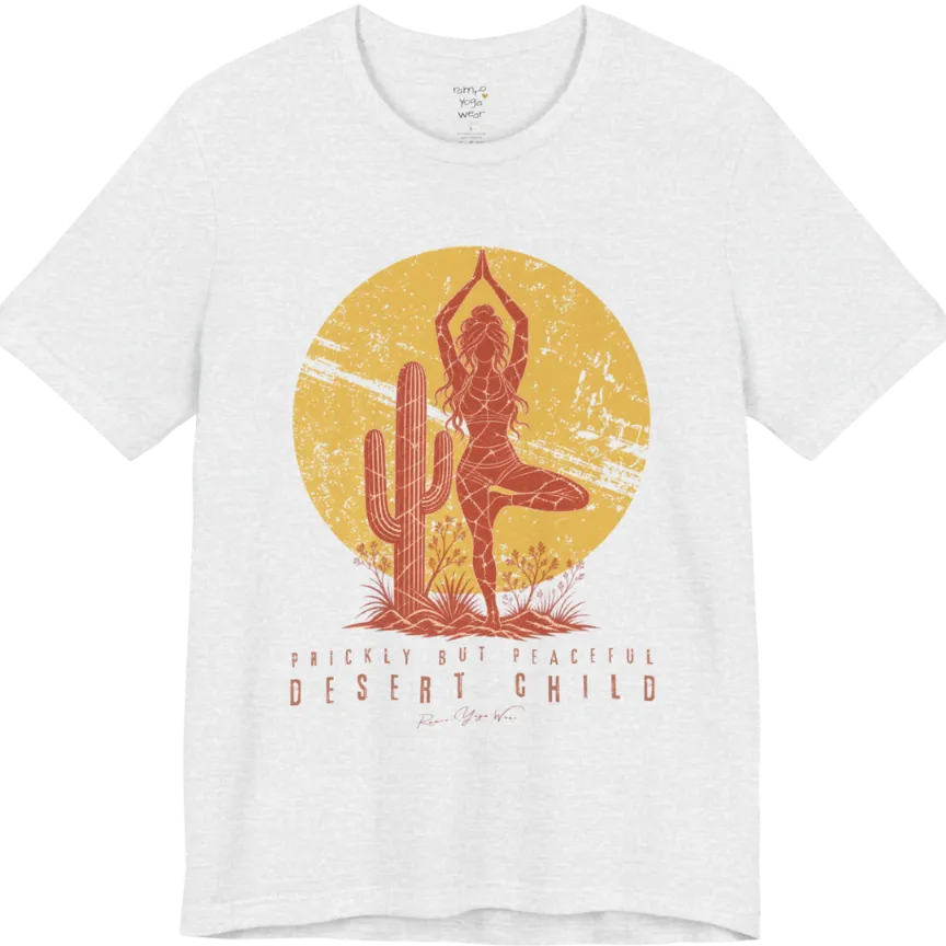 A short sleeved tee called the Desert Child T-Shirt, flat lay and a Bella + Canvas 3001 shirt. Simply says, Prickly But Peaceful, Desert Child. Design highlights a person in Tree Pose beside a desert cactus, with a large distressed sun in the background, in a rustic, distressed illustration. Color is Ash.