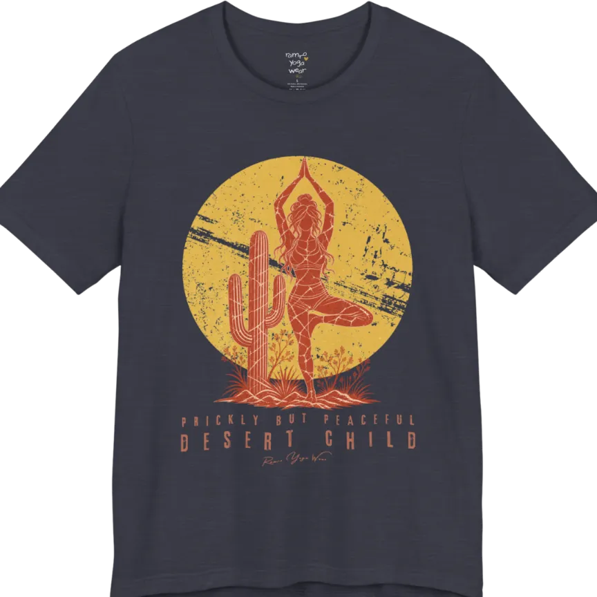 A short sleeved tee called the Desert Child T-Shirt, flat lay and a Bella + Canvas 3001 shirt. Simply says, Prickly But Peaceful, Desert Child. Design highlights a person in Tree Pose beside a desert cactus, with a large distressed sun in the background, in a rustic, distressed illustration. Color is Heather Midnight Navy.