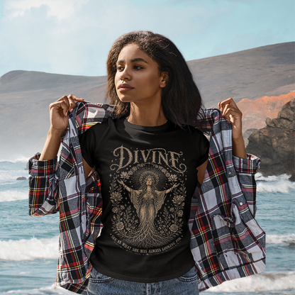 Woman wearing Divine black sacred yoga shirt at the ocean with coastal cliffs — Sacred Thread collection by Ramro Yoga Wear