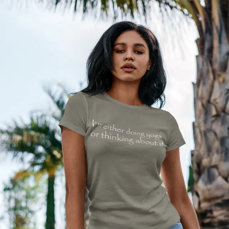 Woman wearing Doing Yoga Heather Military Green T-Shirt outdoors near palm trees — The Vault collection by Ramro Yoga Wear