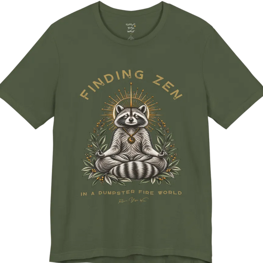 A short sleeved Tee of a meditating raccoon illustration with a gold sunburst halo and botanical leaf framing. Dumpster T-Shirt flat lay is a Bella+Canvas 3001 and the color is Military Green.