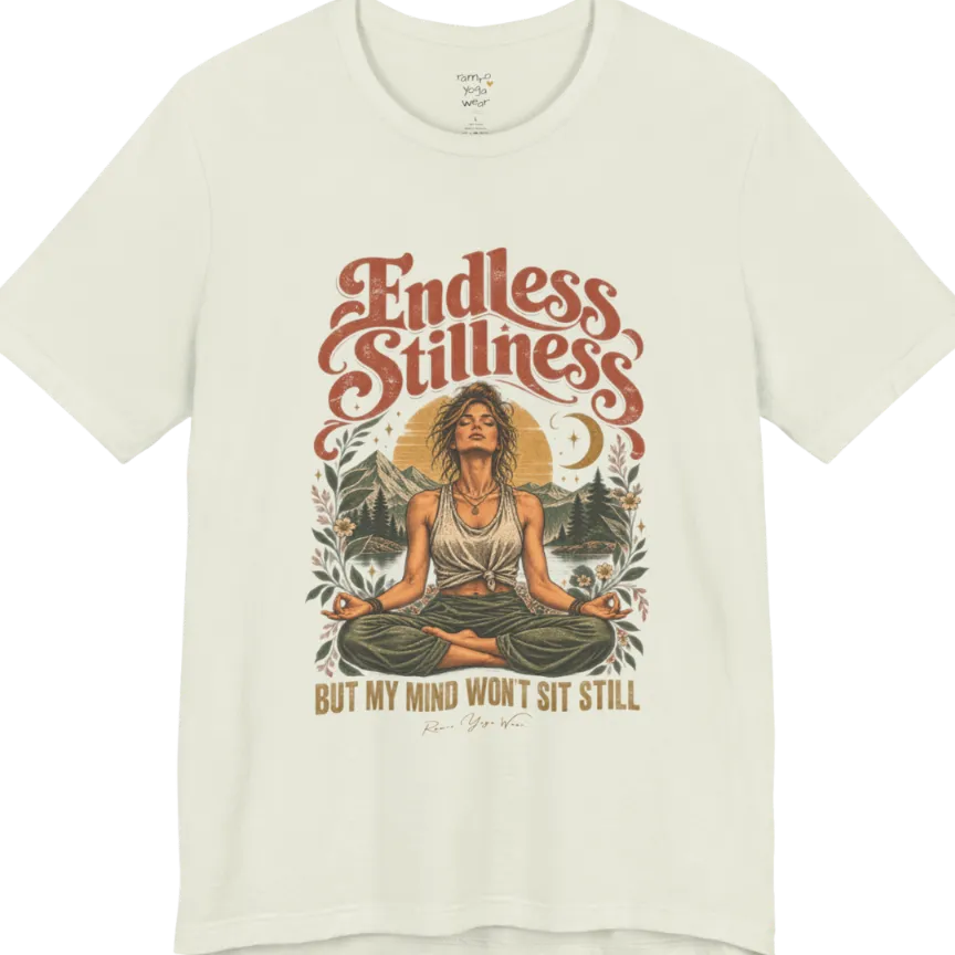 A short sleeved tee, showing an Illustration of a woman seated in lotus meditation pose in front of mountains, pine trees, and a crescent moon, framed by botanical leaves and flowers. Endless T-Shirt flat lay is a Bella+Canvas 3001 and the color is Citron.