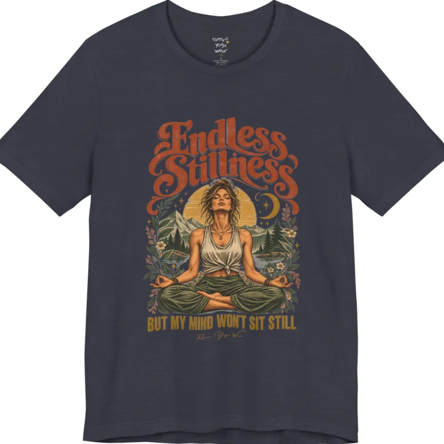 A short sleeved tee, showing an Illustration of a woman seated in lotus meditation pose in front of mountains, pine trees, and a crescent moon, framed by botanical leaves and flowers. Endless T-Shirt flat lay is a Bella+Canvas 3001 and the color is Heather Midnight Navy.