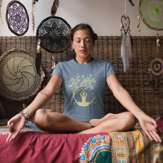 Woman wearing Evening Meditation T-Shirt Stone Blue sacred yoga shirt meditating indoors in a relaxed boho setting — The Vault collection by Ramro Yoga Wear