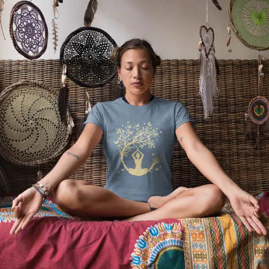 Evening Meditation T-Shirt lifestyle image with woman meditating cross-legged, peaceful and grounded yoga lifestyle.