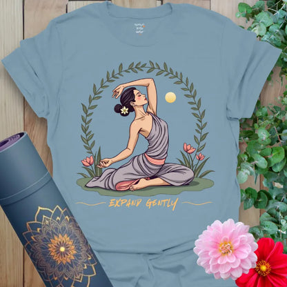 Muted stone blue yoga t-shirt featuring gentle expansion illustration with yogini, sun, and flowers for spiritual journeying.
