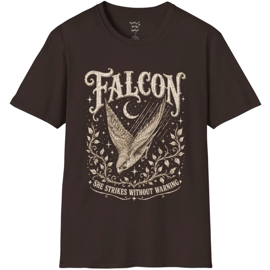 A grunge tee with an illustrated falcon wing design, crescent moon, and botanical linework, text reading "Falcon" and "She Strikes Without Warning" — Wild Animals collection by Ramro Yoga Wear in Dark Chocolate.