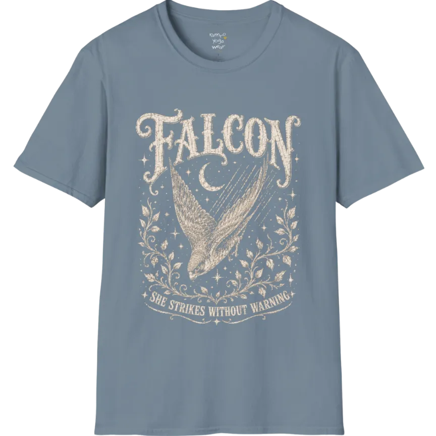 A grunge tee with an illustrated falcon wing design, crescent moon, and botanical linework, text reading "Falcon" and "She Strikes Without Warning" — Wild Animals collection by Ramro Yoga Wear in Stone Blue.